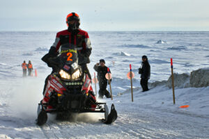 Iron Dog racers coming into Nome during the race in 2014. Photo: KNOM file.