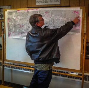 Nome City Council member Jerald Brown points to an area of land on the zoning map. Photo: Matthew F. Smith, KNOM.