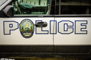 Block letters spelling "POLICE" on the side of a Nome Police Department SUV.