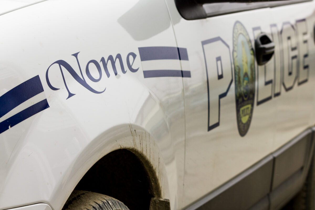 Close-up of a white Nome Police Department vehicle.