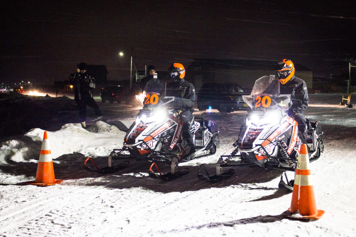 Iron Dog victors Eric Quam and Scott Faeo leave the Nome halfway point amid blowing snow days before winning the 2015 race in Fairbanks. Photo: Jenn Ruckel, Francesca Fenzi, KNOM.