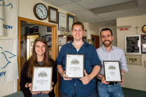 Kristin, Matthew, and David, holding AK Press Club awards