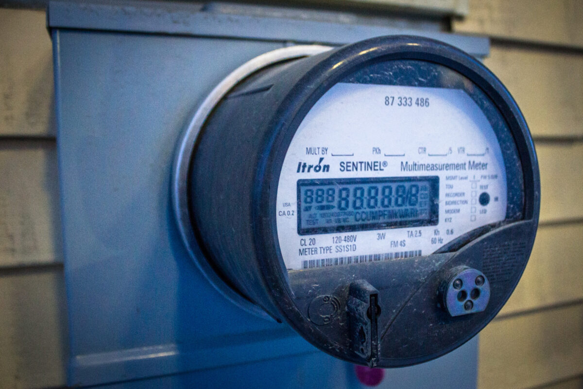 A close-up view of a utility meter on the side of a Nome building.