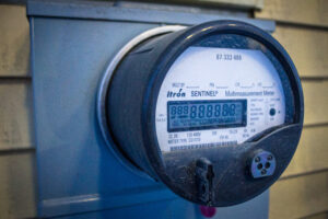 A close-up view of a utility meter on the side of a Nome building.