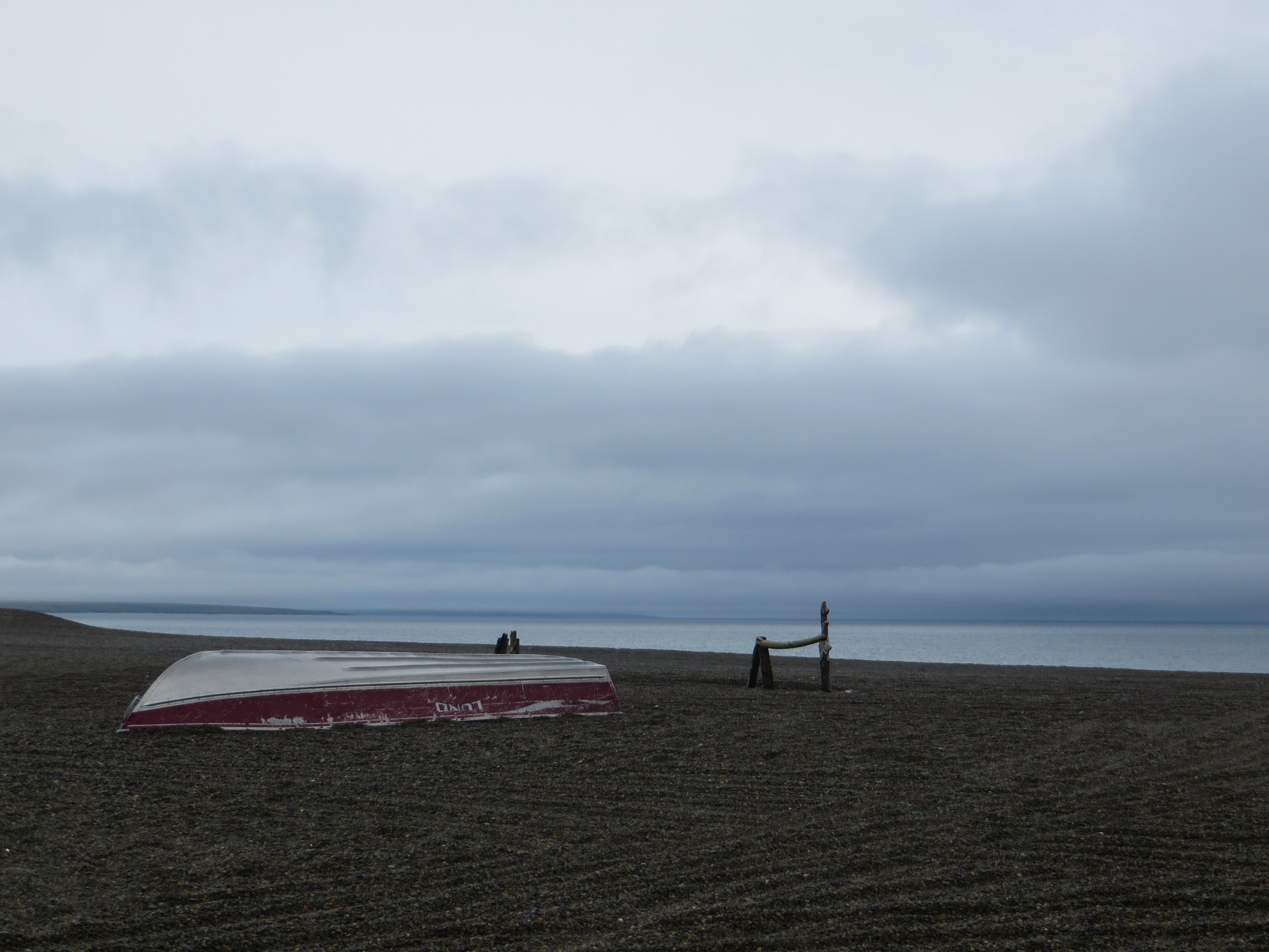 A boat resting on the beach on a cloudy summer day in Gambell, Alaska.