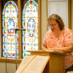 Lynette offers a reading during Mass