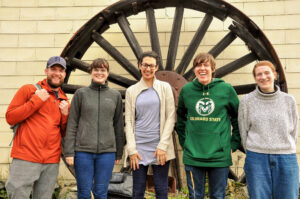 Davis, Lauren, Margaret, Tyler, and Karen stand in front of their retreat cabin.