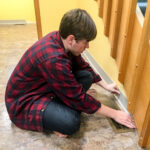 Tyler helps with kitchen flooring work