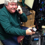 Engineer Joe Mauk helps install KNOM's new telephone system
