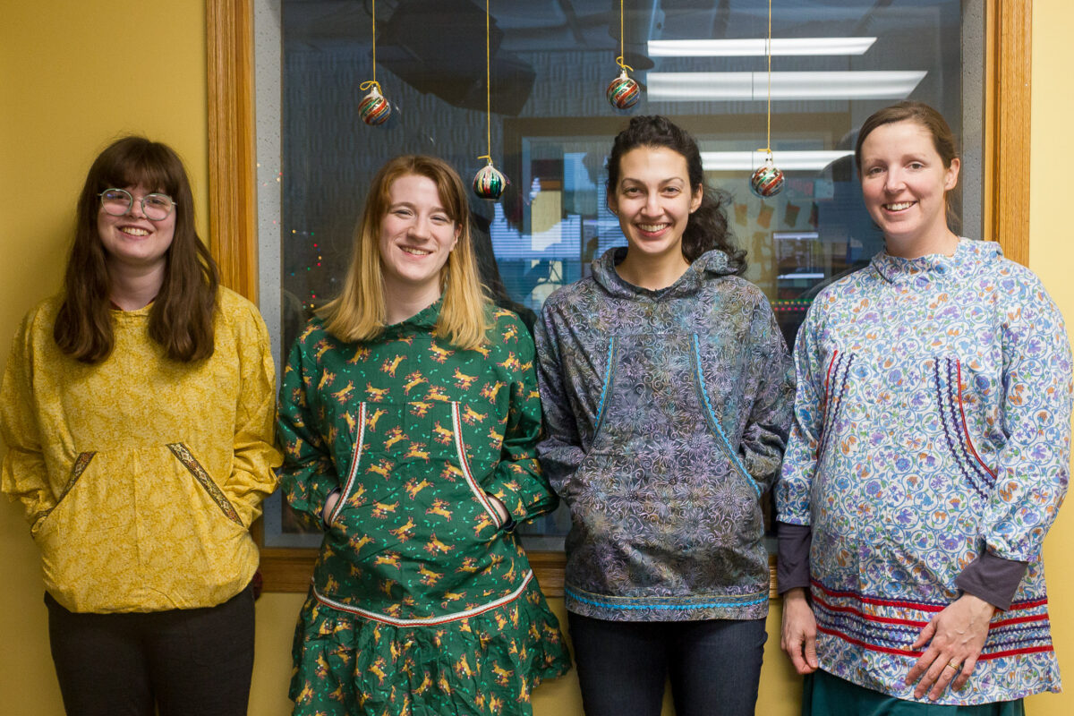 Lauren, Karen, Margaret, and Laura, wearing homemade kuspuks inside KNOM studios.