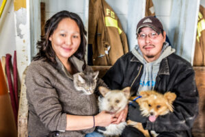 Eileen and Ashley Moses hold their pets inside the Elim Fire Hall