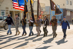 Veterans carry flags in Nome's Memorial Day parade.
