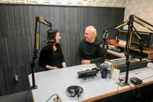 Margaret and Ric chat inside a radio studio