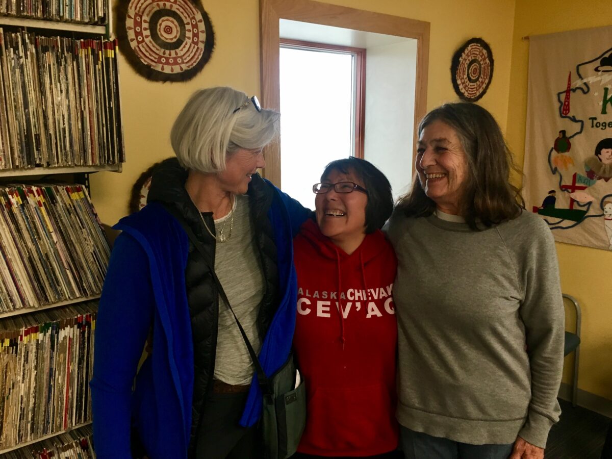 Tandy Wallack, Etta Tall, and documentary filmmaker Lourdes Grobet laugh together in the the KNOM studios, where they stopped by before heading to Little Diomede for a long-awaited family reunion.