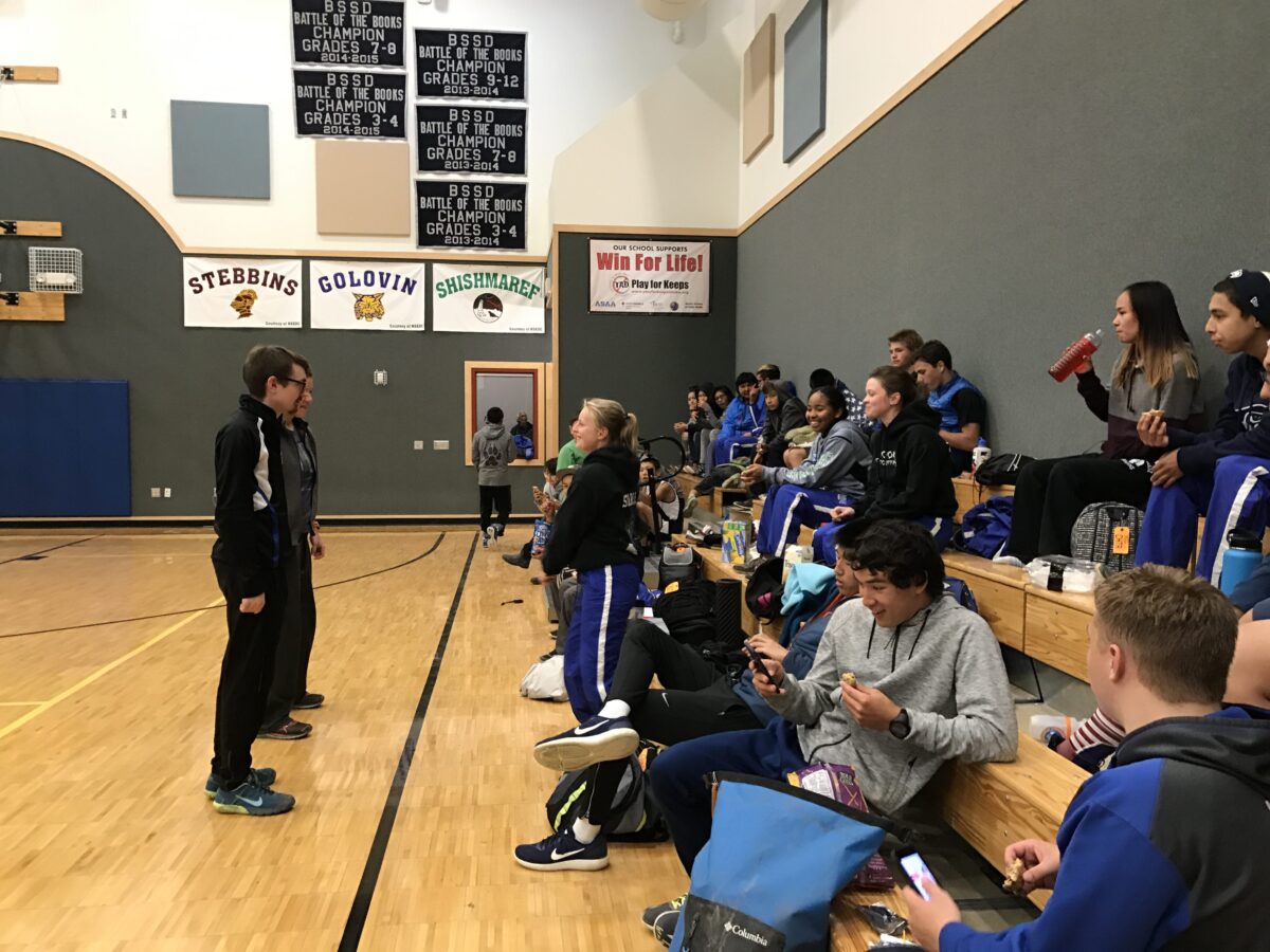 The Nome and White Mountain cross-country running teams relax before the awards ceremony in the White Mountain School gym
