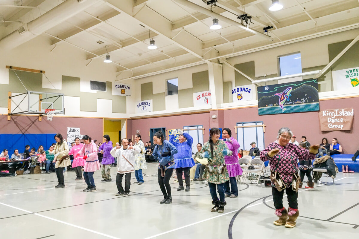 Alaska Native dancing inside the Wales gymnasium