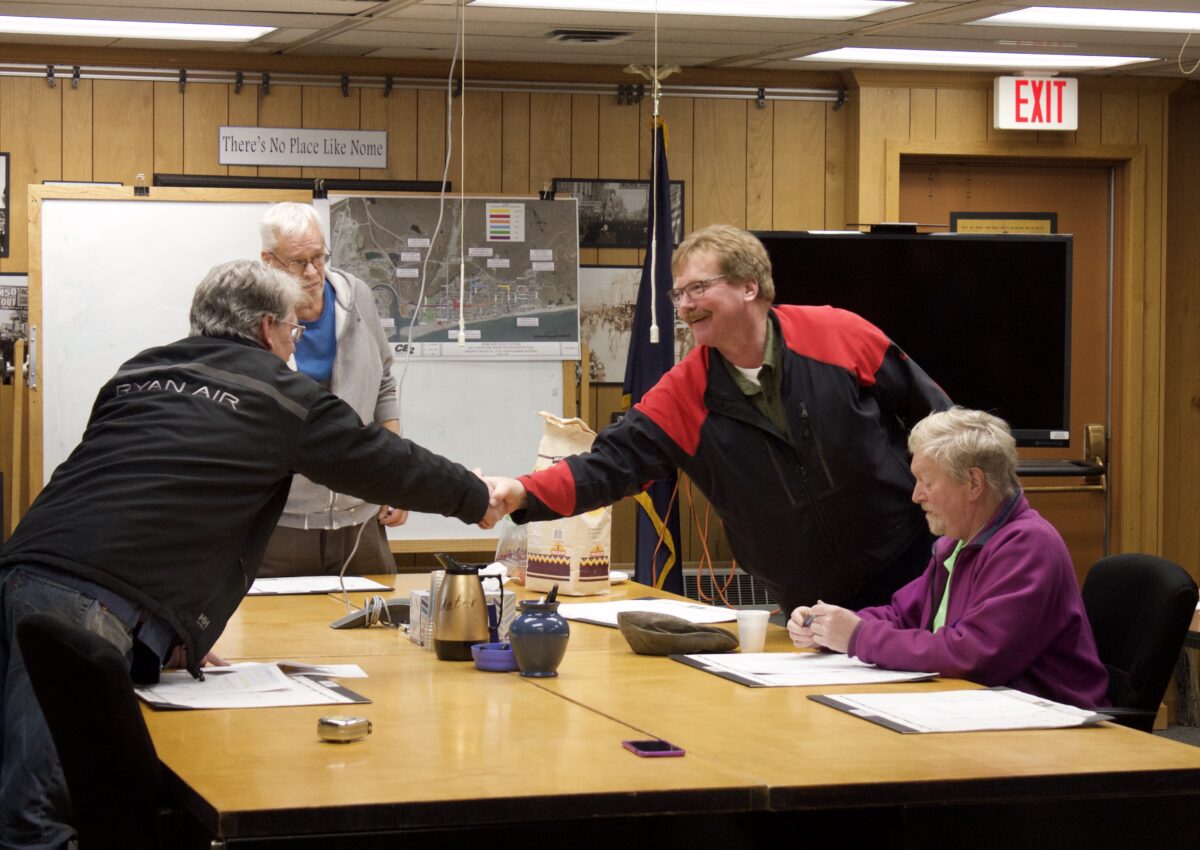 Sparks shakes Brown's hand during Spark's last City Council meeting. The former Councilman completed the "handoff" with Adam Martinson who will now hold Seat A on the Council. Photo Credit: Davis Hovey, KNOM (2017)