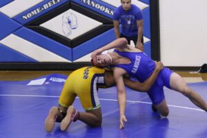 Nome's Aaron Rose wrestles a Bethel student at the 2017 Nome Invite (Photo: Janeen Sullivan, used with permission)