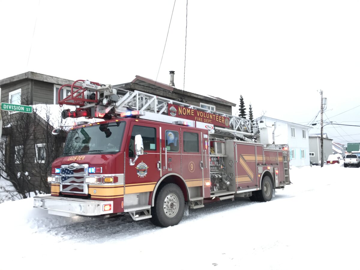 A fire engine from the Nome Volunteer Fire Department is parked on the snow-covered Division. Nome volunteer fire responded to a truck fire in the parking lot of Old St. Joe's.