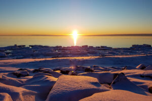 Sunset over the snow and ice of Nome’s winter shoreline.
