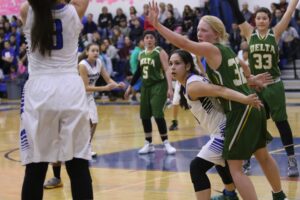 Nanooks girls, in white, play against Delta-Greely, in green, on the Nome-Beltz court