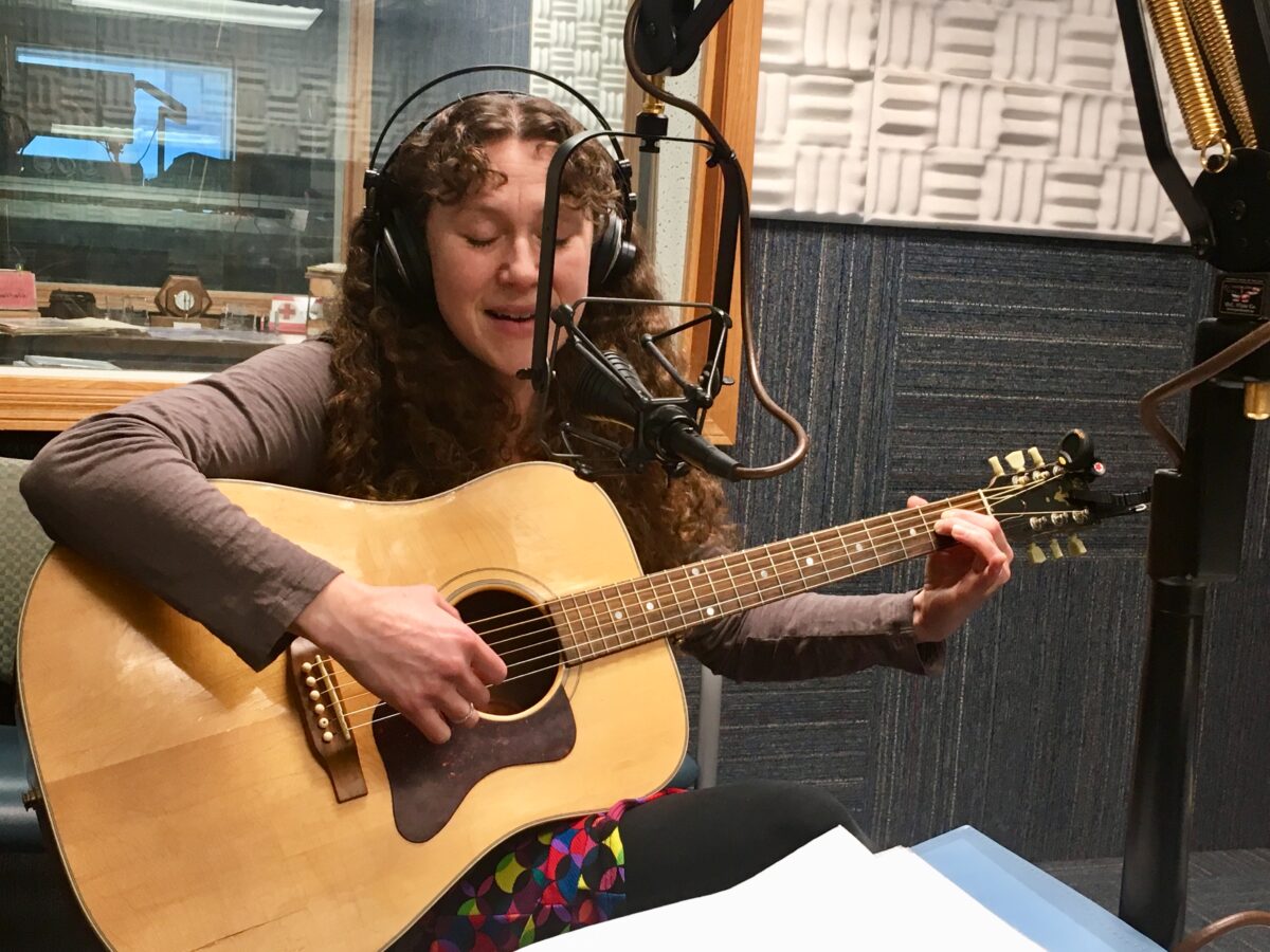 Sarah Hanson Hofstetter plays her guitar in the KNOM studios.