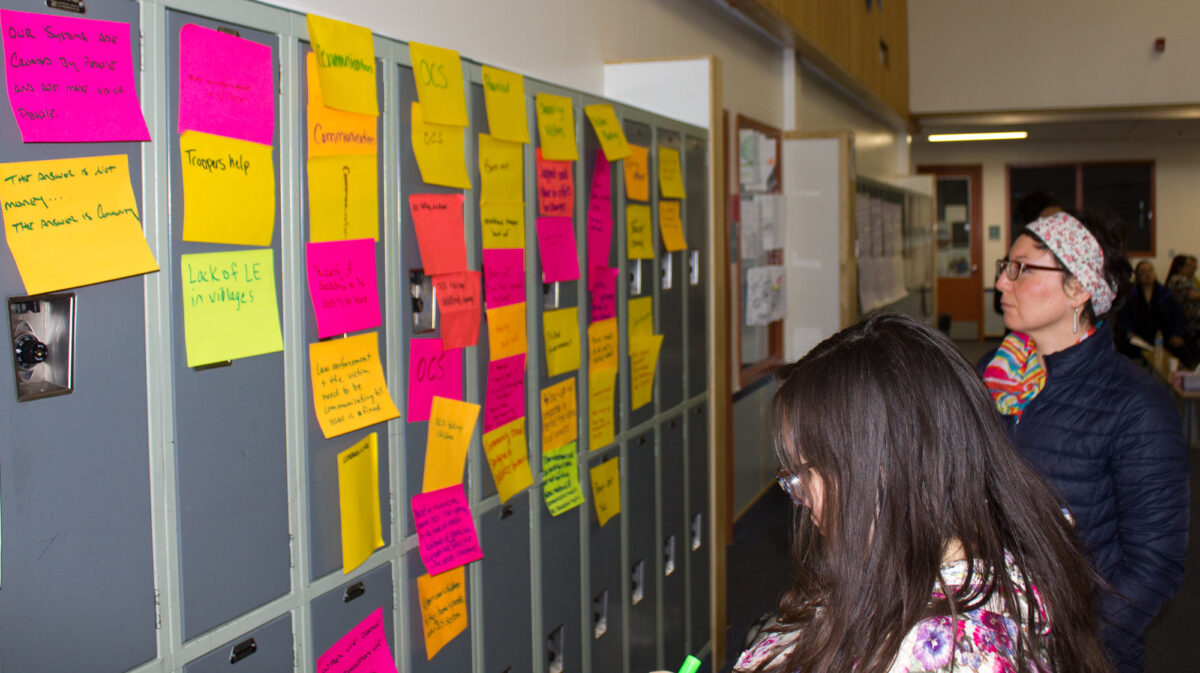 Panganga Pungowiyi/(Pangaanga Pangawyi) and Lisa Ellanna from Kawerak review the post-it notes full of suggested changes related to sexual assault and domestic violence. Photo Credit: Davis Hovey, KNOM (2018)