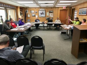 The Nome Port Commission sits around tables in Council Chambers in May 2018.