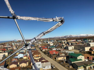 An aerial view of Nome from atop KNOM's downtown FM transmitter tower; in the immediate foreground is the wireframe of the newly-rebuilt Christmas star.