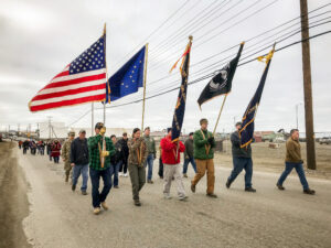 Color guard, bearing flags, leads the 2018 Memorial Day parade through Nome.