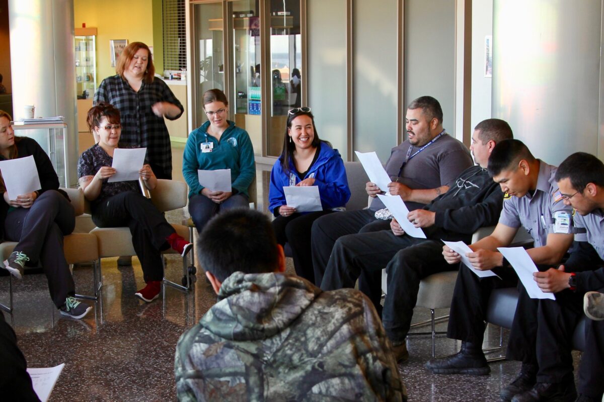 People sit in a group learning Iñupiaq sounds at Norton Sound Regional Hospital