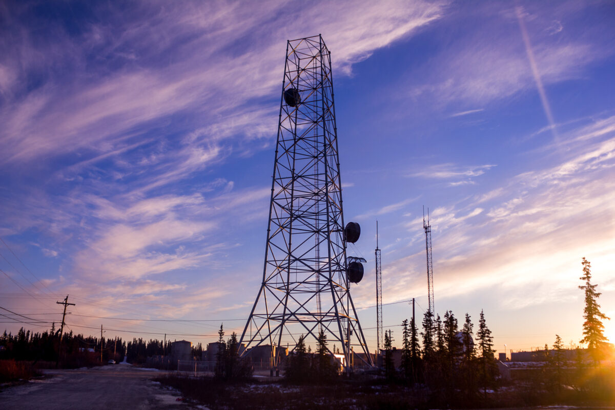 Silhouette of internet tower in Noorvik, Alaska, at sunset.