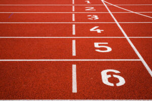 A reddish brown cross-country track, with a close-up view of the starting lines.