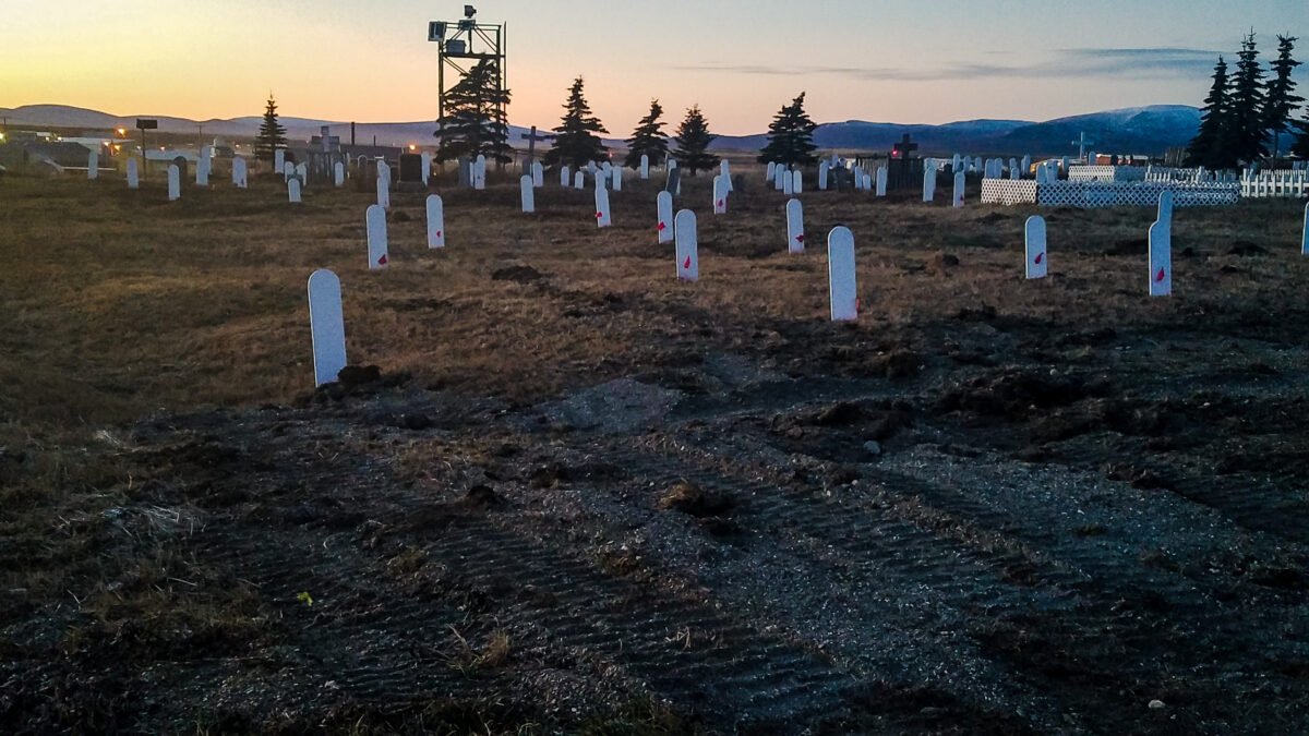 Landscape view of plain white grave markers at the Nome cemetery.