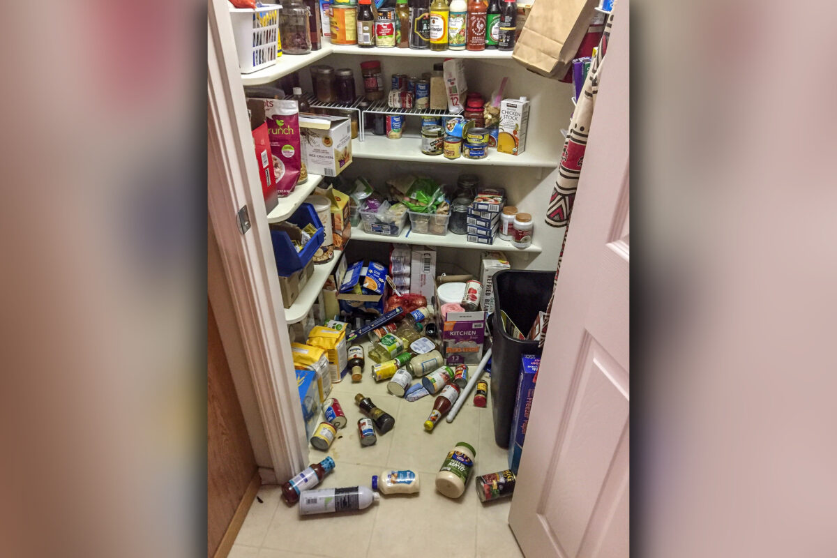 Photo of walk-in pantry with canned goods scattered across the floor