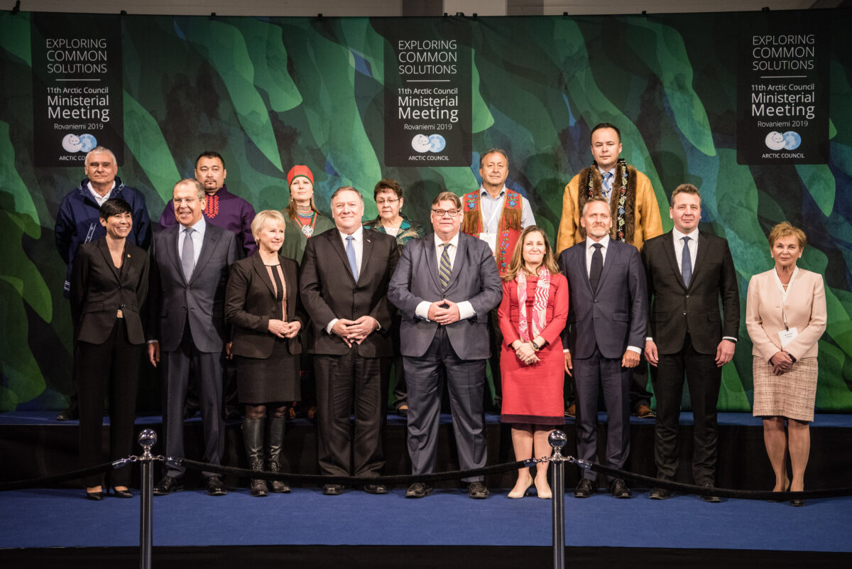 Group picture of international representatives in business clothes at Arctic Council meeting