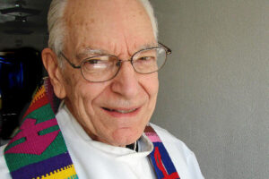 A picture of Father Armand wearing a colorful stola.