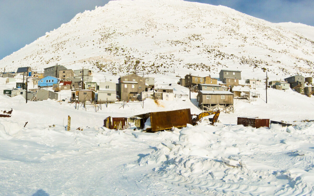 A photo of homes and buildings in Diomede, a small community on an island in the Bering Sea.