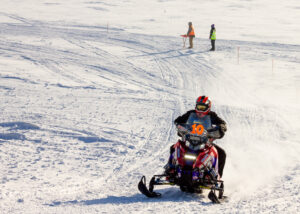 Snow machine racer on trail.