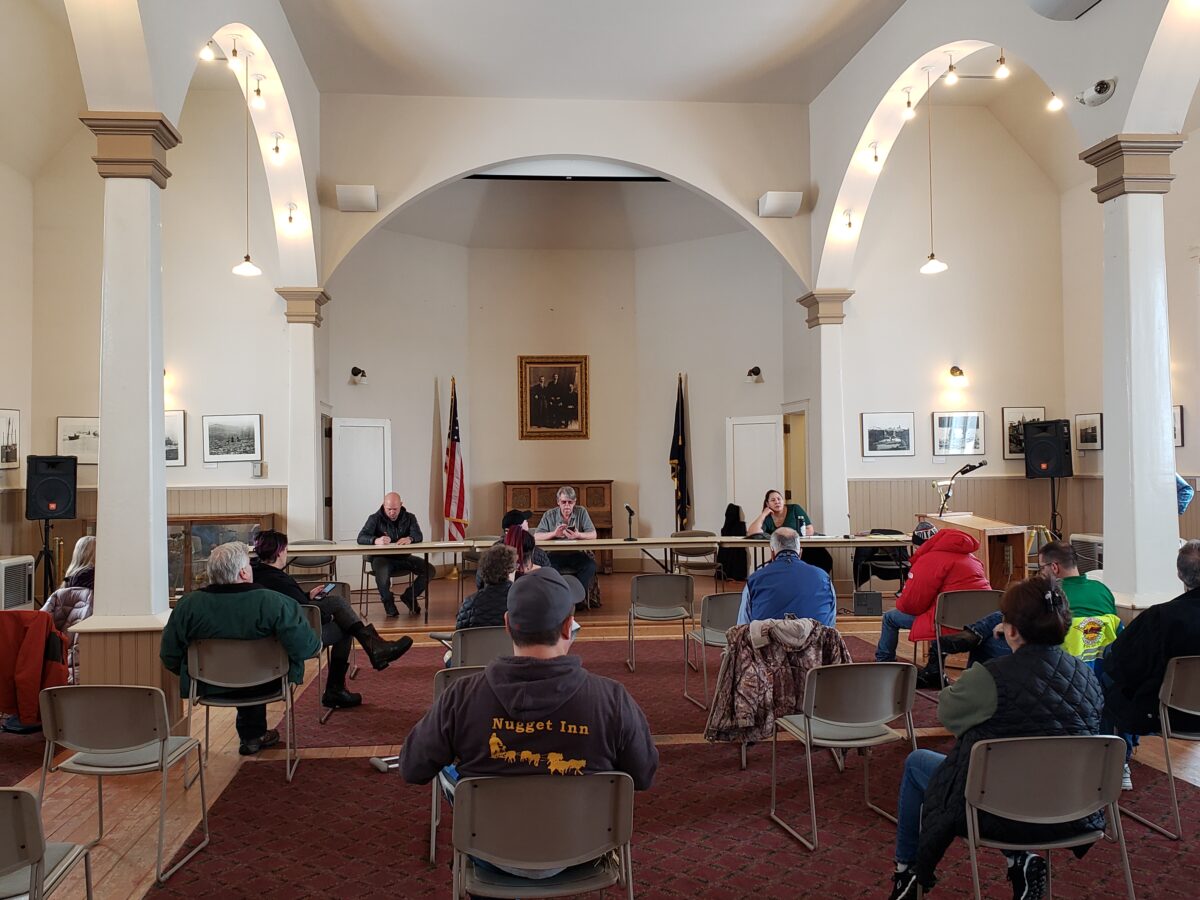 Group of people sitting in chairs have a meeting in church building.
