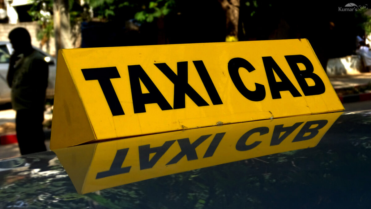 Picture of taxi cab sign on top of cab