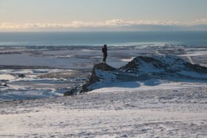 Woman standing on hill overlooking Nome.
