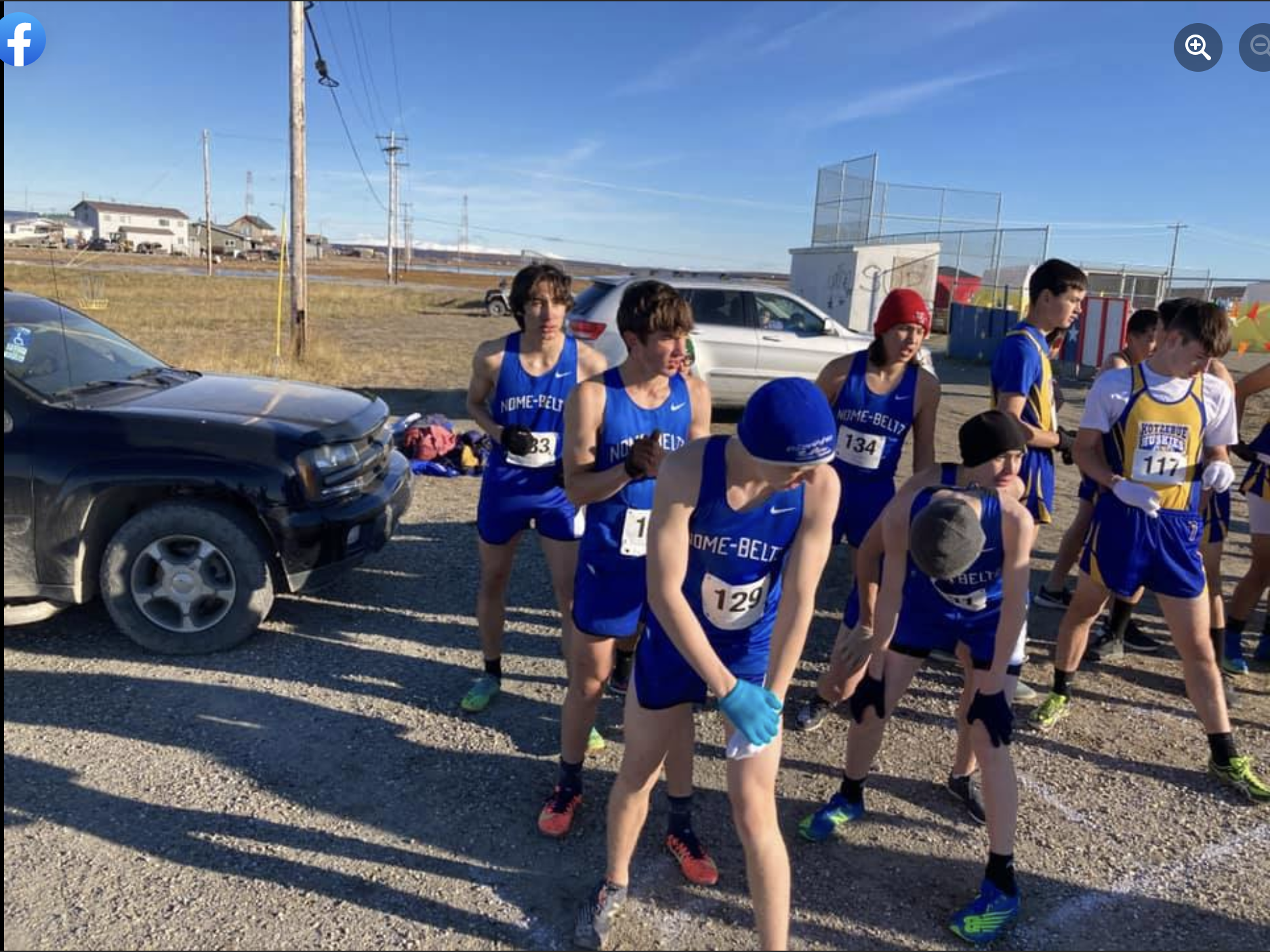 A group of cross country boys waiting to start race outside.