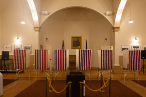 Red and white stripped election booths inside a church.