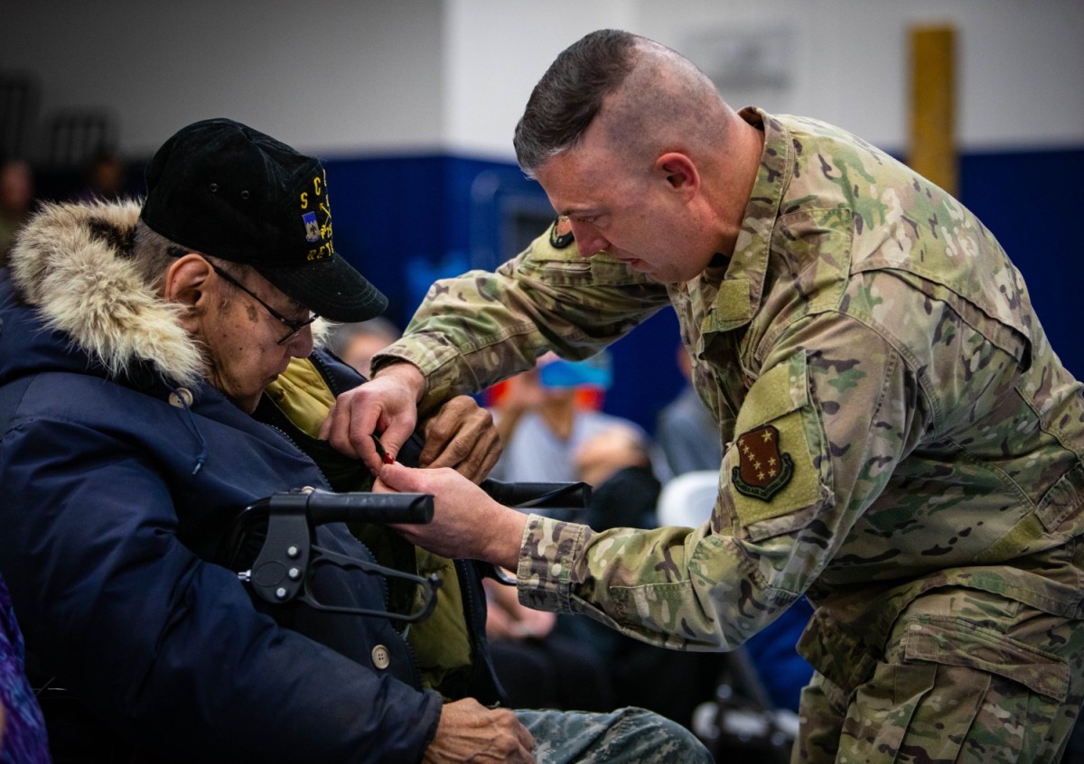 Maj. Gen. Torrence Saxe pins the Alaska Heroism Medal on Cpl. Bruce Boolowon in Gambell. Photo courtesy Robert DeBerry/Alaska National Guard (2023)