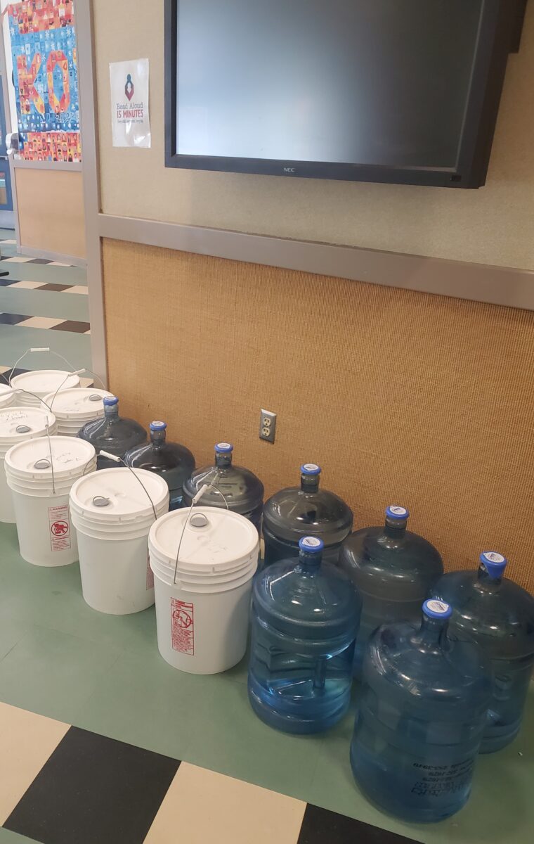 Bottled water and buckets are being used at Koyuk Malimiut School. Photo courtesy Koyuk Malimiut School (2023)