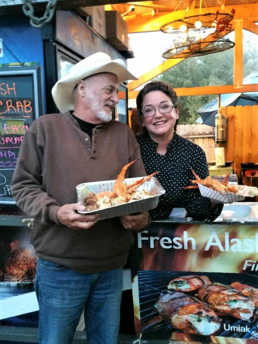 Meyer (left) shows off a seafood dish with singer-songwriter Hobo Jim. Photo courtesy Buffy Meyer