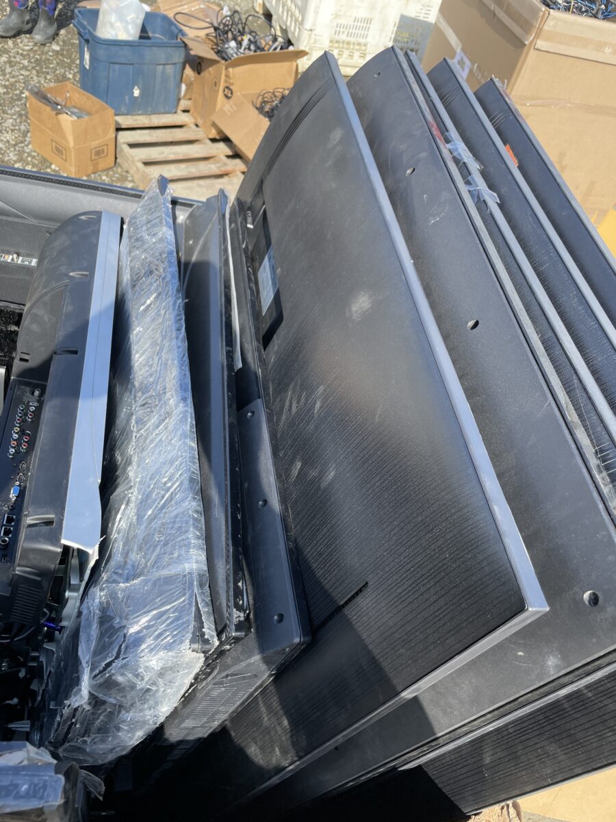 A box full of discarded television sets and smart boards at the e-waste collection event.