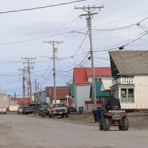 An ATV rider cruises down a street in Nome on Wednesday, June 7.