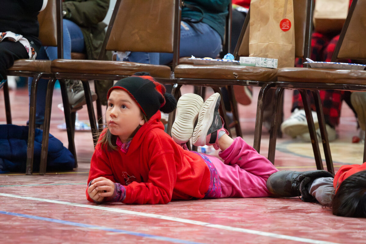 A young attendee watches from the floor of the Nome Recreation Center as Ingrid Goodyear speaks to the crowd. Ben Townsend photo.